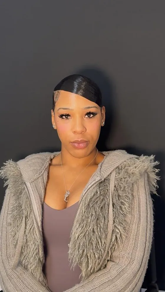 Sharp side part slicked back with sculpted edges