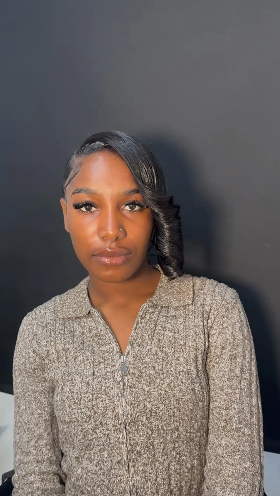 Close portrait of a client wearing a sleek side swoop